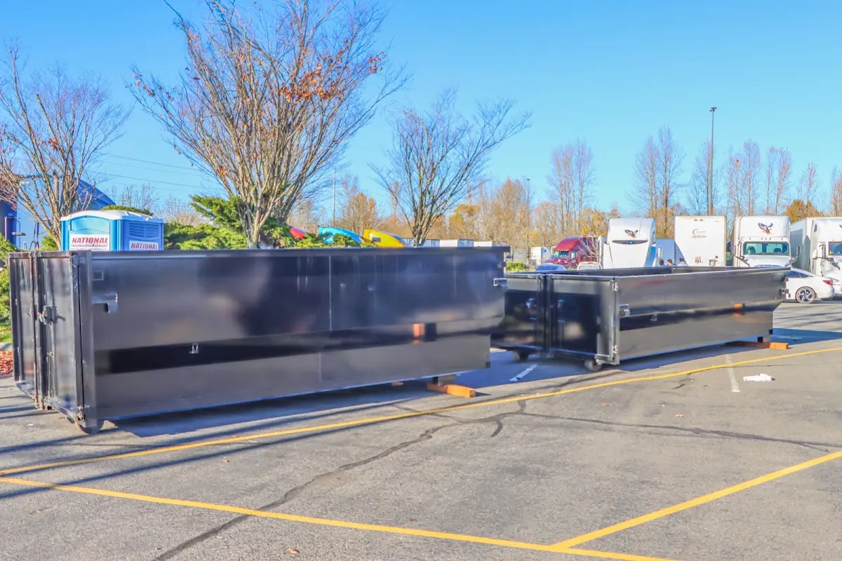 Professional dumpster rental service with roll-off container on residential driveway in Northdale